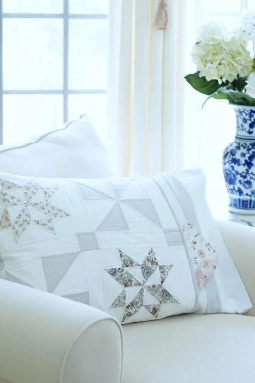 Stardust Shimmer Quilt displayed over chaise with Blue Vase